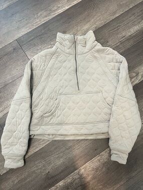 Womens Lululemon Scuba Oversized Quilted Half Zip in a light beige color.